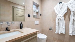 A modern bathroom with a sink, mirror, towel rack, and toilet. - Hôtel Villa d'Estrées - Saint-Germain (Paris)