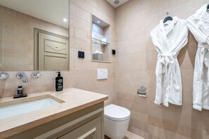A modern bathroom with a sink, mirror, towel rack, and toilet. - Hôtel Villa d'Estrées - Saint-Germain (Paris)
