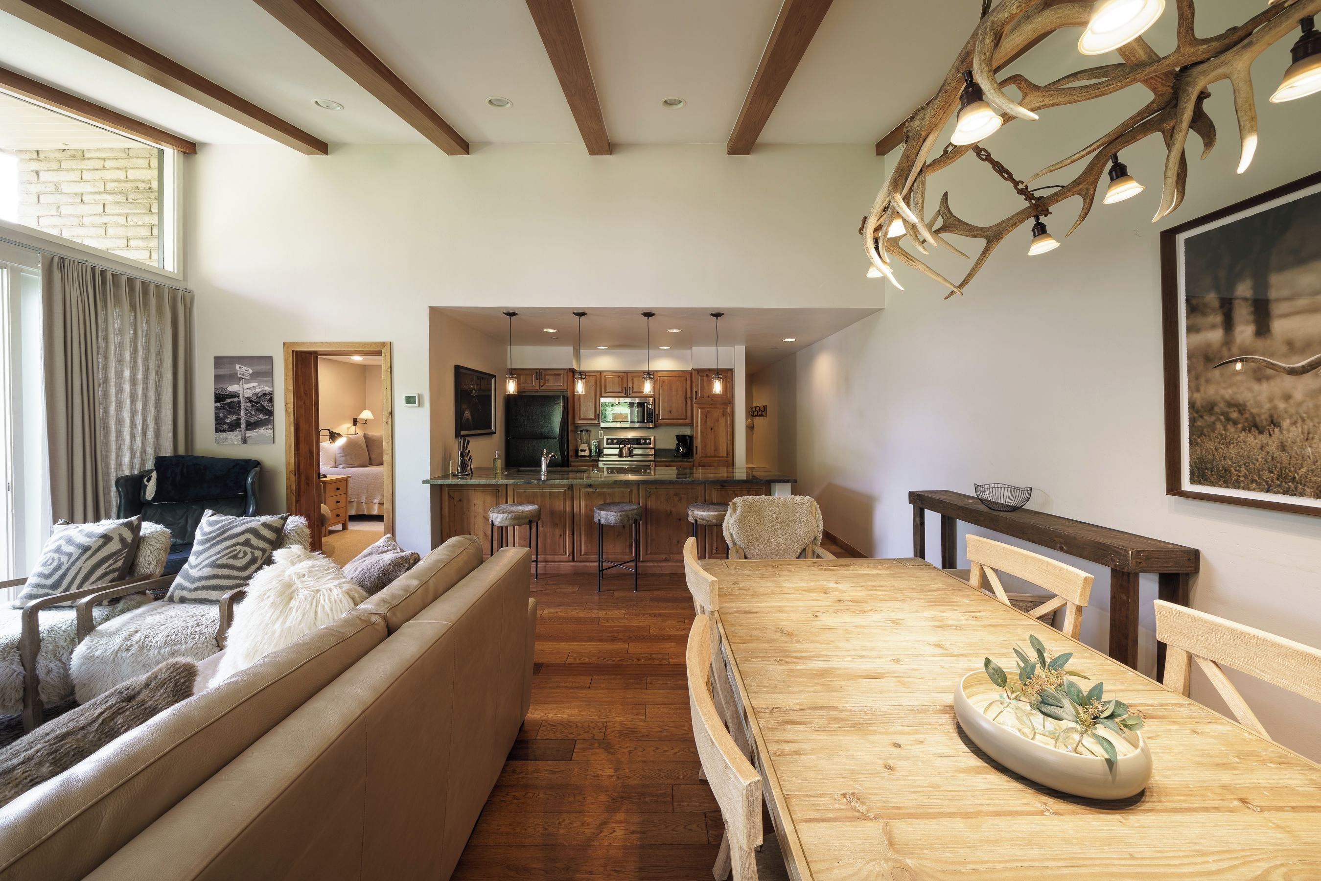 A modern interior with a dining area, kitchen, and living space.