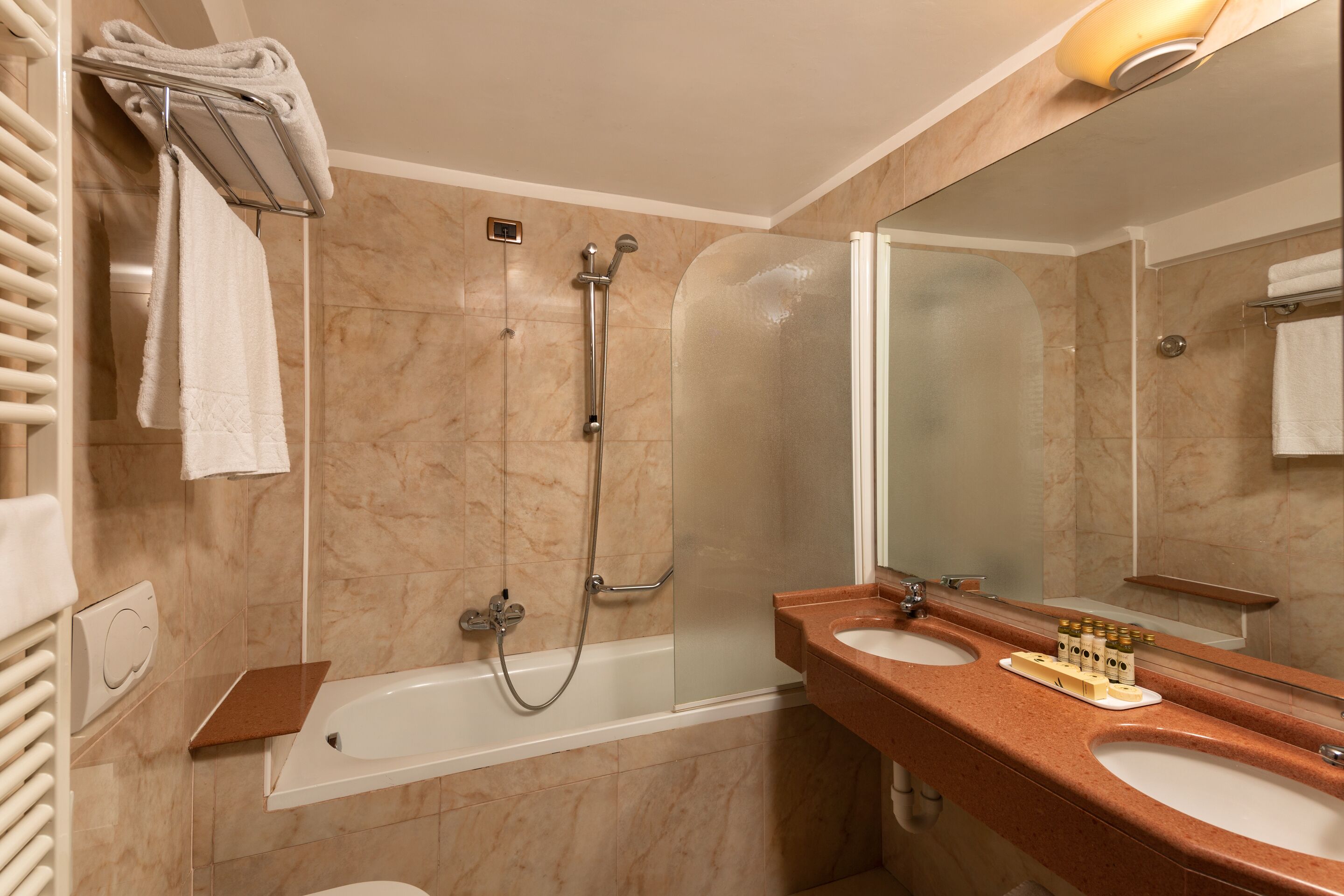 A bathroom with a bathtub, a shower, and two sinks.