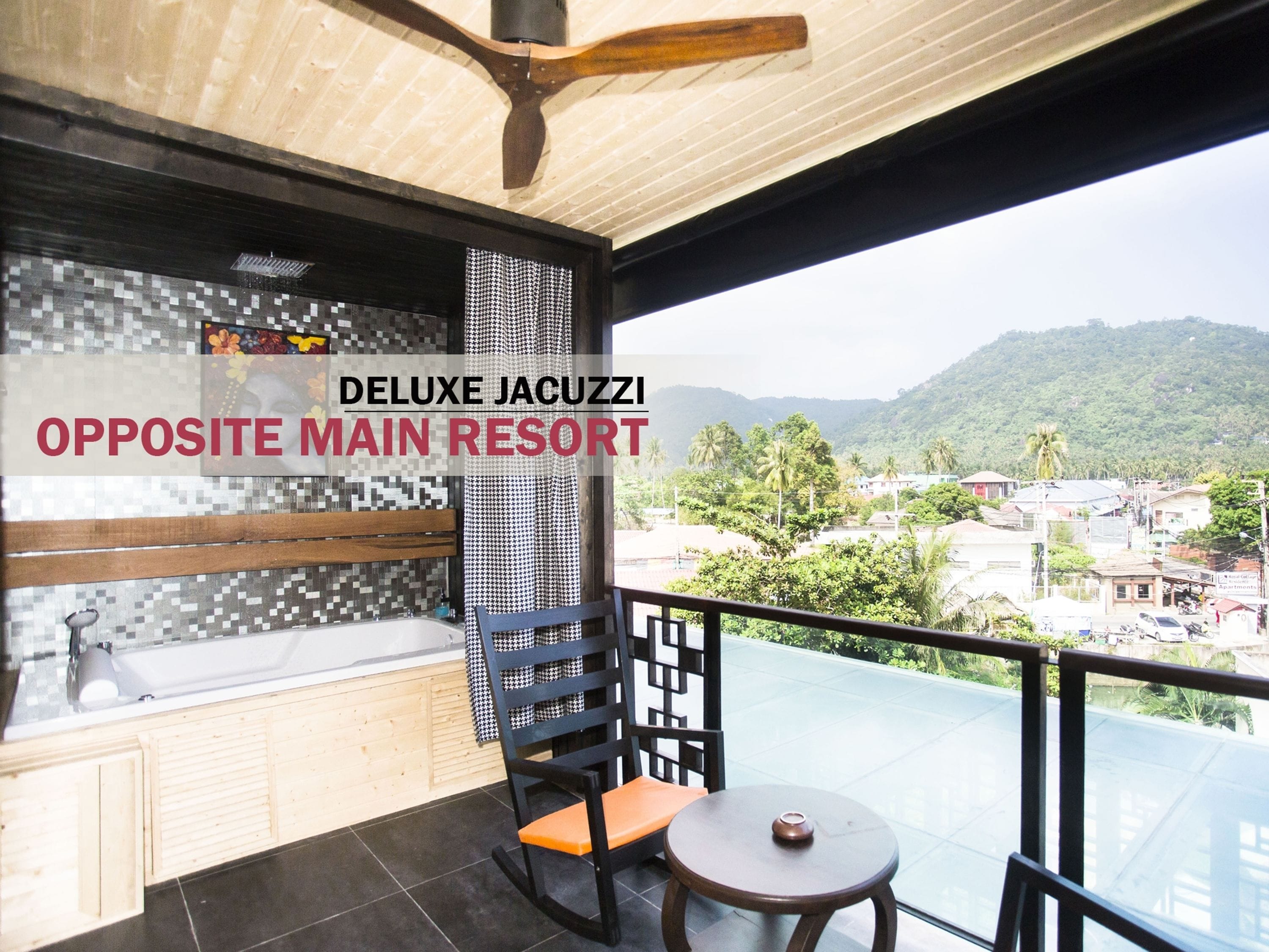 A balcony with a view of a mountainous landscape, a ceiling fan, and a chair with an orange cushion.