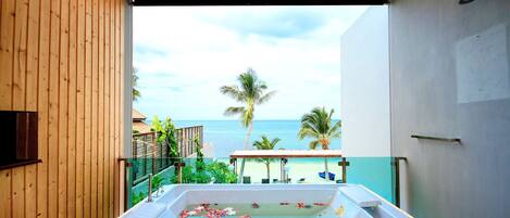 A wooden-enclosed room with a view of the beach and ocean.