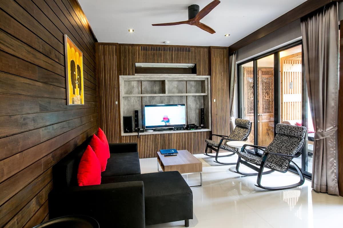 two bedroom pool residence | living area | 32-inch smart tv with satellite channels, books