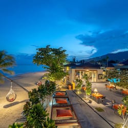 On the beach, white sand, sun loungers, beach umbrellas