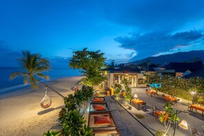 On the beach, white sand, sun loungers, beach umbrellas