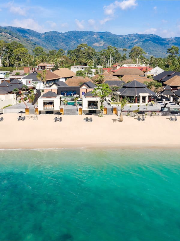On the beach, white sand, sun loungers, beach umbrellas