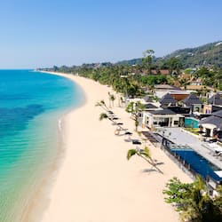 On the beach, white sand, sun loungers, beach umbrellas