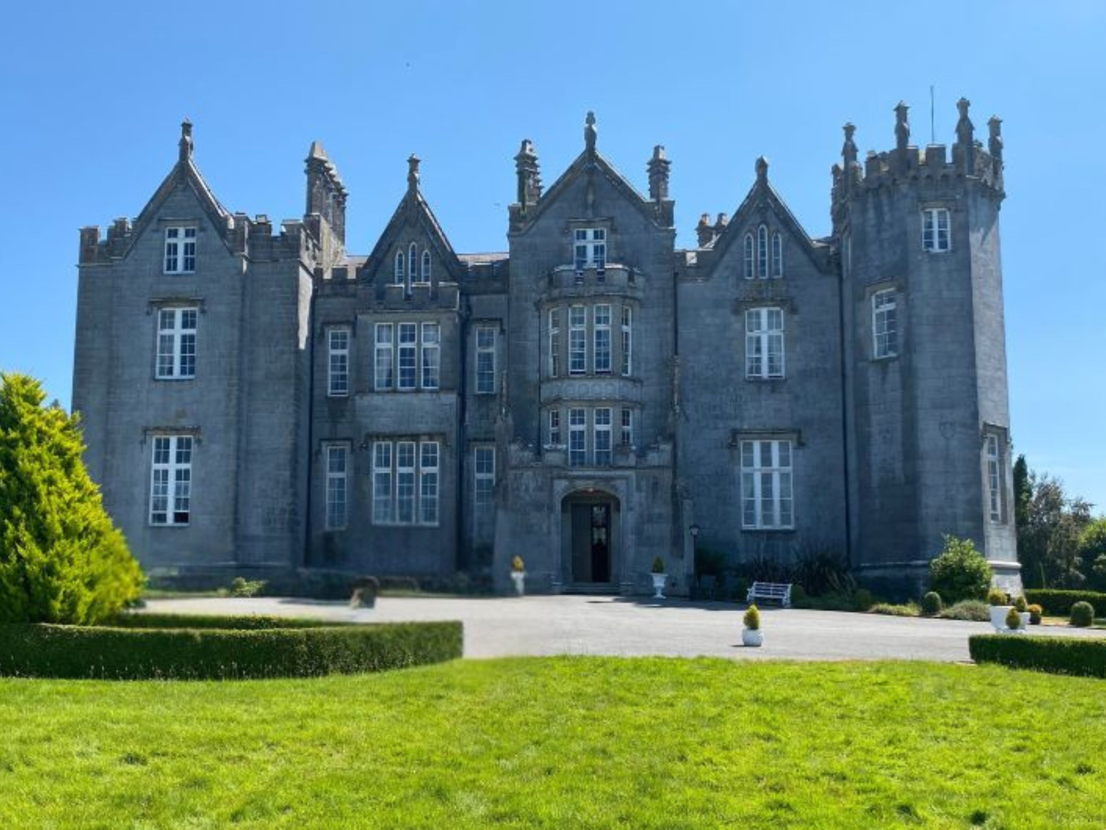 A large, historic building with multiple towers and a symmetrical facade.