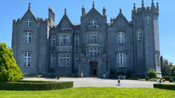 A large, historic building with multiple towers and a symmetrical facade.