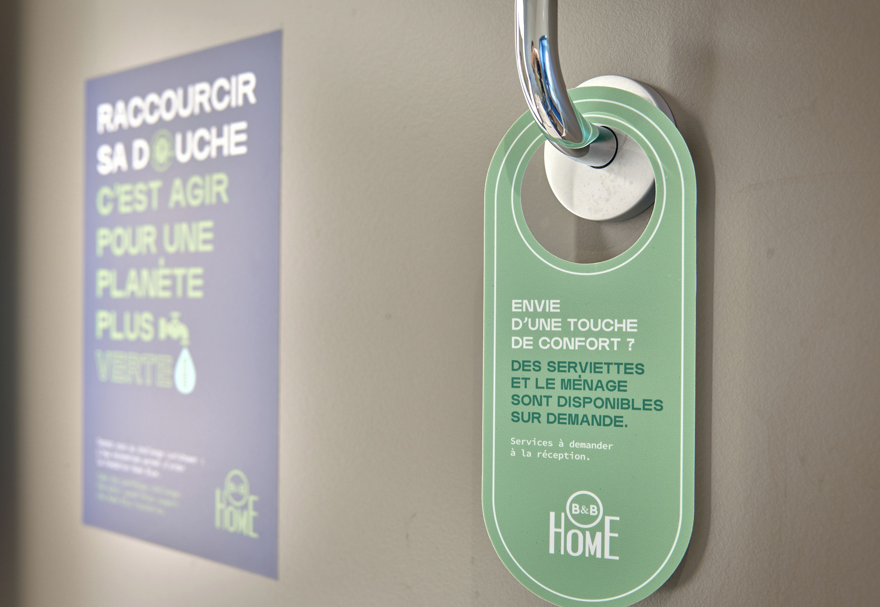 A green tag with text in French, hanging from a metal fixture.