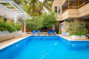 Piscine extérieure, parasols, chaises longues