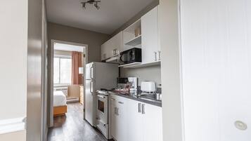 Suite, 1 grand lit et 1 canapé-lit | Cuisine privée | Réfrigérateur, micro-ondes, cafetière/bouilloire, grille-pain