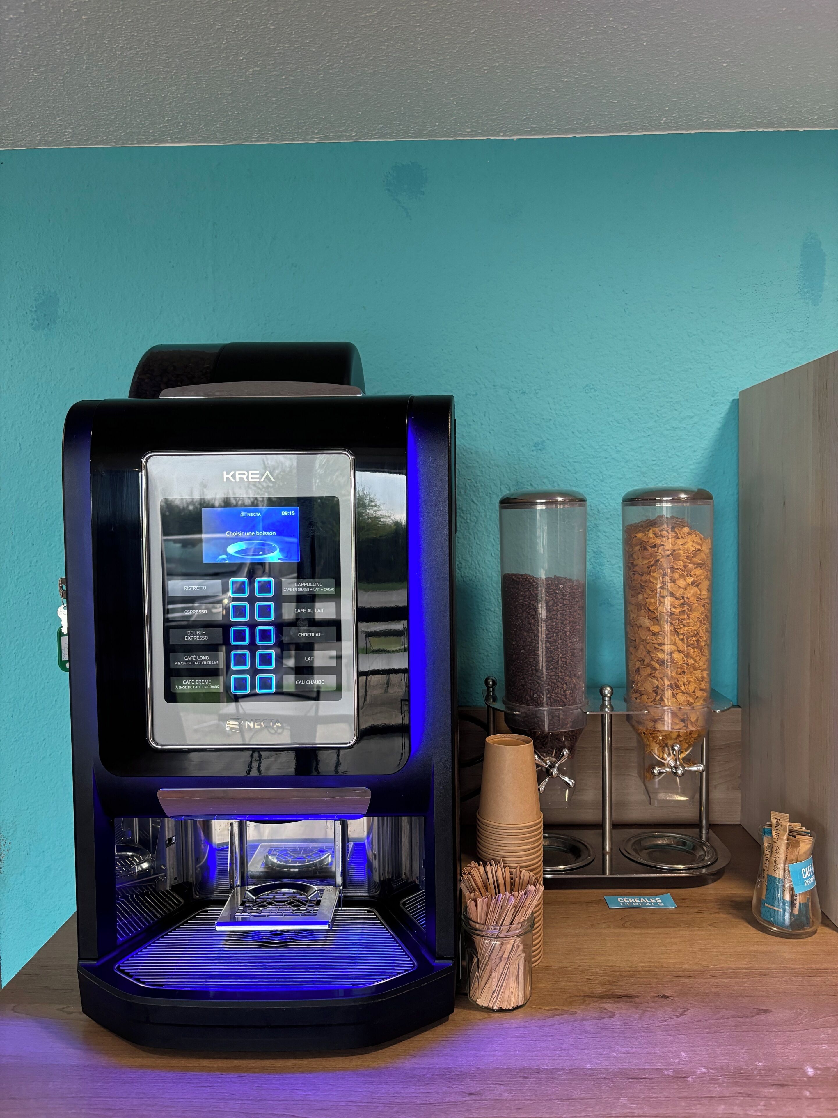 A coffee machine with a digital display, two coffee dispensers, and a coffee cup holder.
