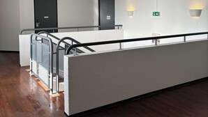 A modern hotel lobby with a long reception desk, a staircase, and a wooden floor. - Kyriad Direct Dreux (Dreux)