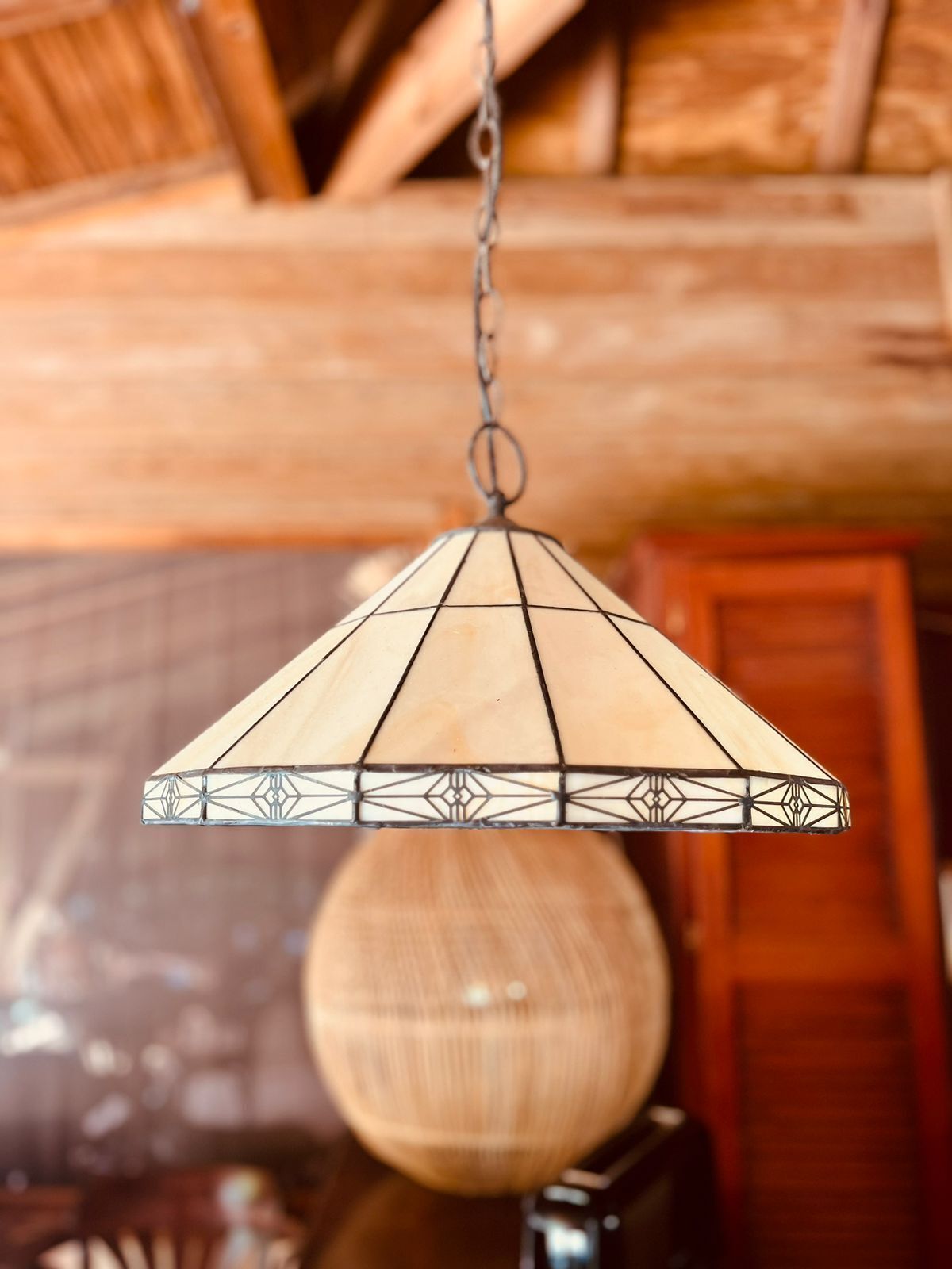 A hanging light fixture with a geometric design.