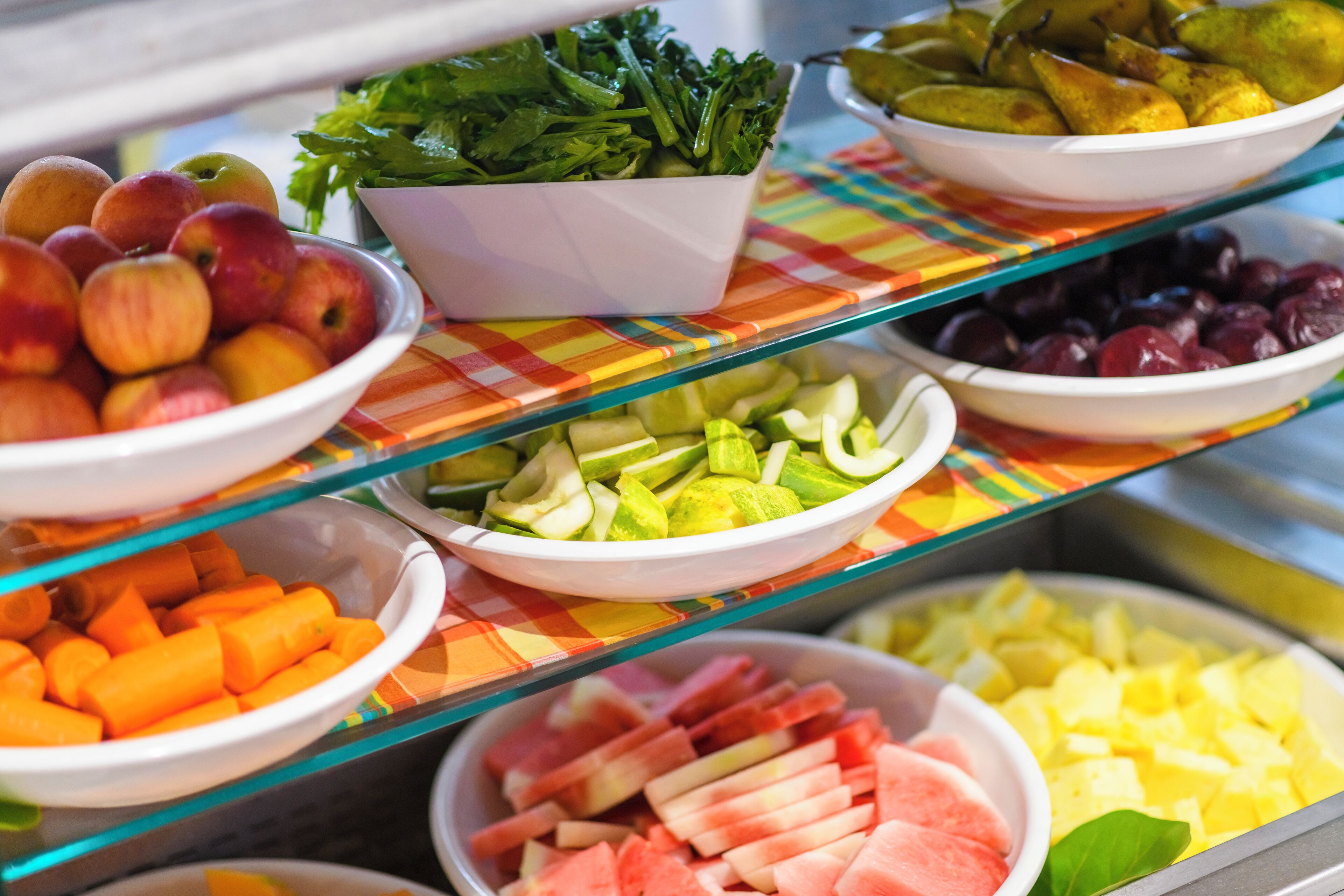 A buffet with various fruits and vegetables.