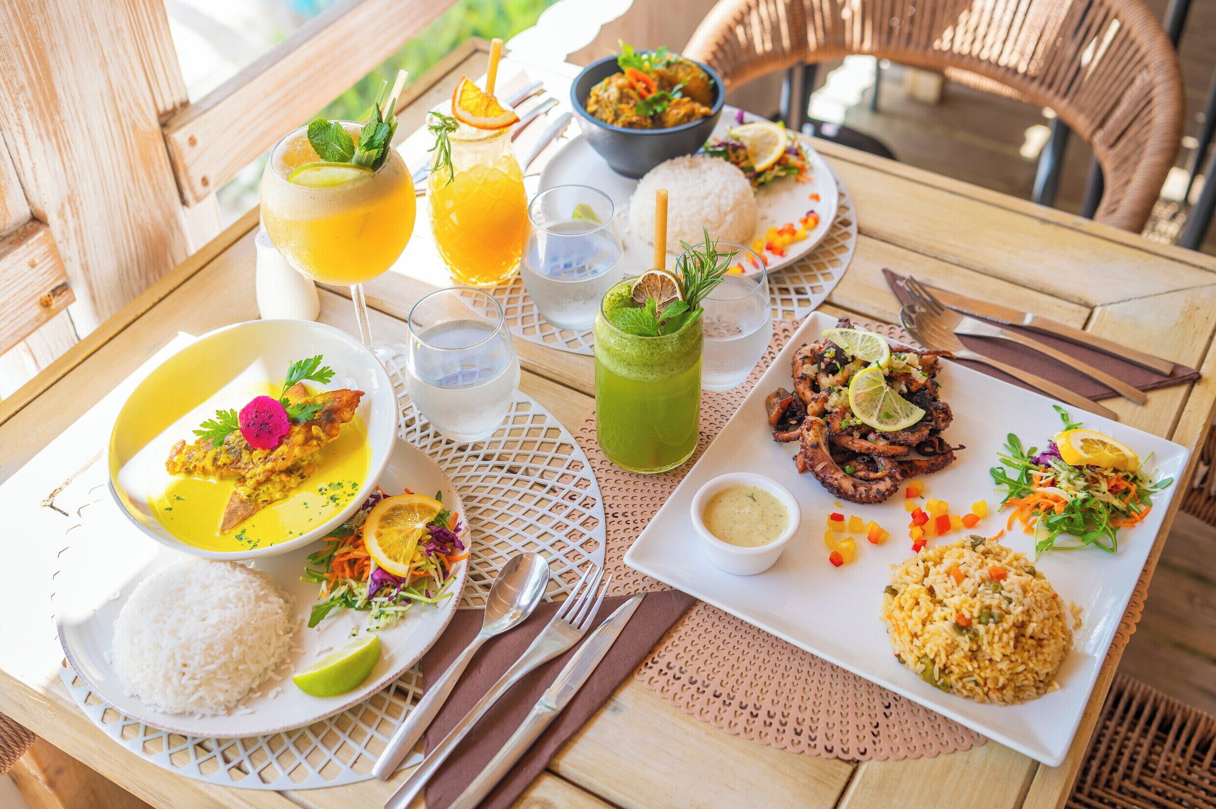 A table set with various dishes, drinks, and utensils, suggesting a dining experience.