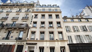 A multi-story hotel with balconies, a sign for 'Garden Saint Martin', and a 'HOTEL' sign on the facade. - Garden Saint Martin (Paris)