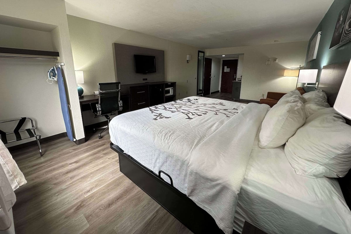 Premium bedding, desk, laptop workspace, blackout drapes