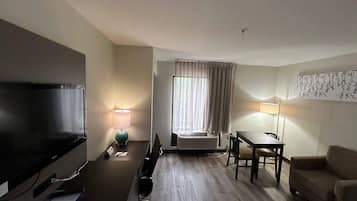 Premium bedding, desk, laptop workspace, blackout drapes