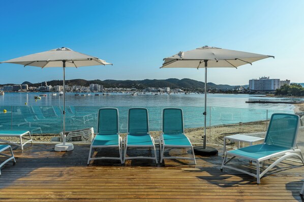 Piscine extérieure, parasols de plage, chaises longues