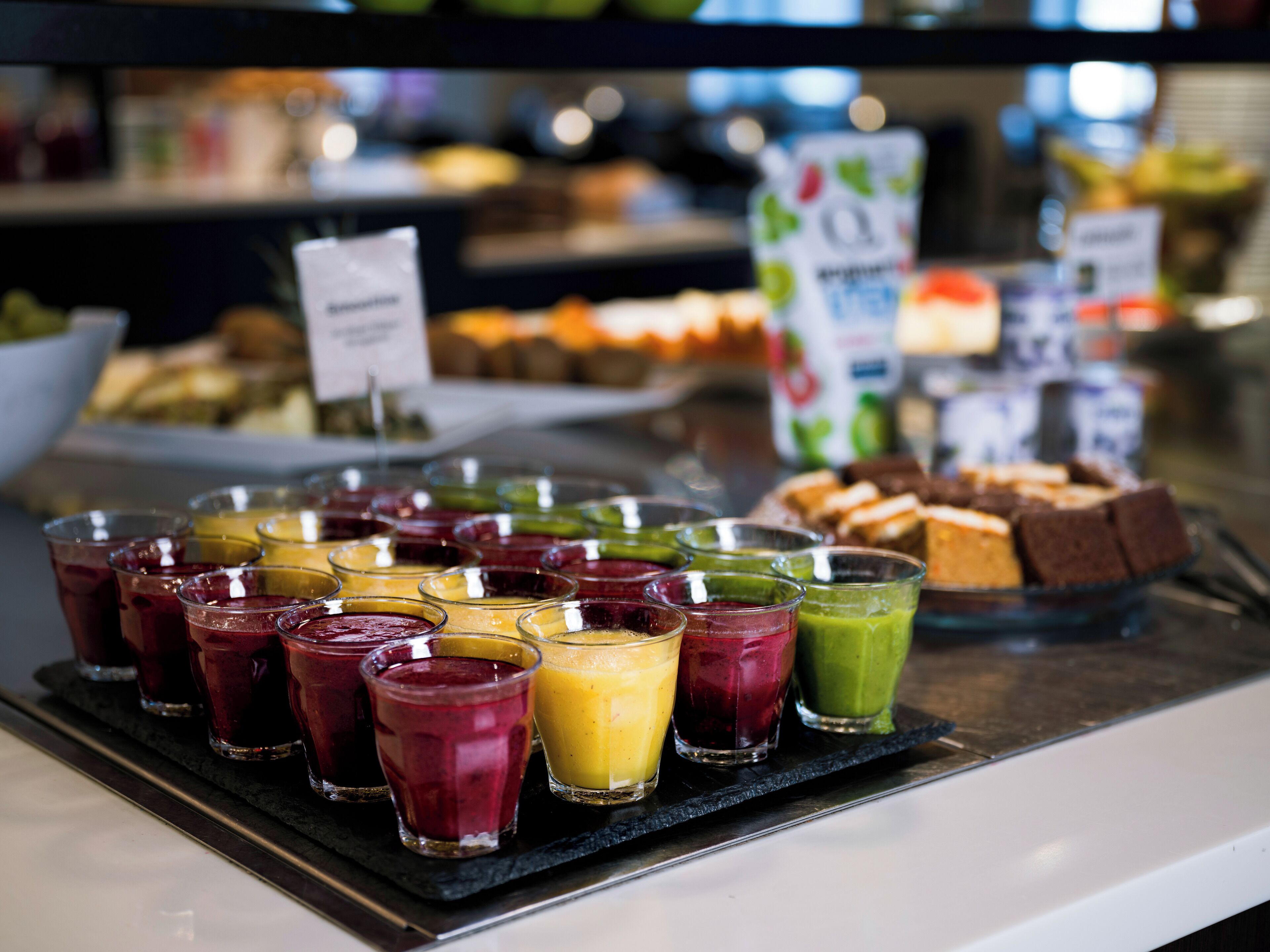 A buffet with various food items and drinks.