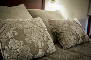 Una cama con dos almohadas con estampado floral.