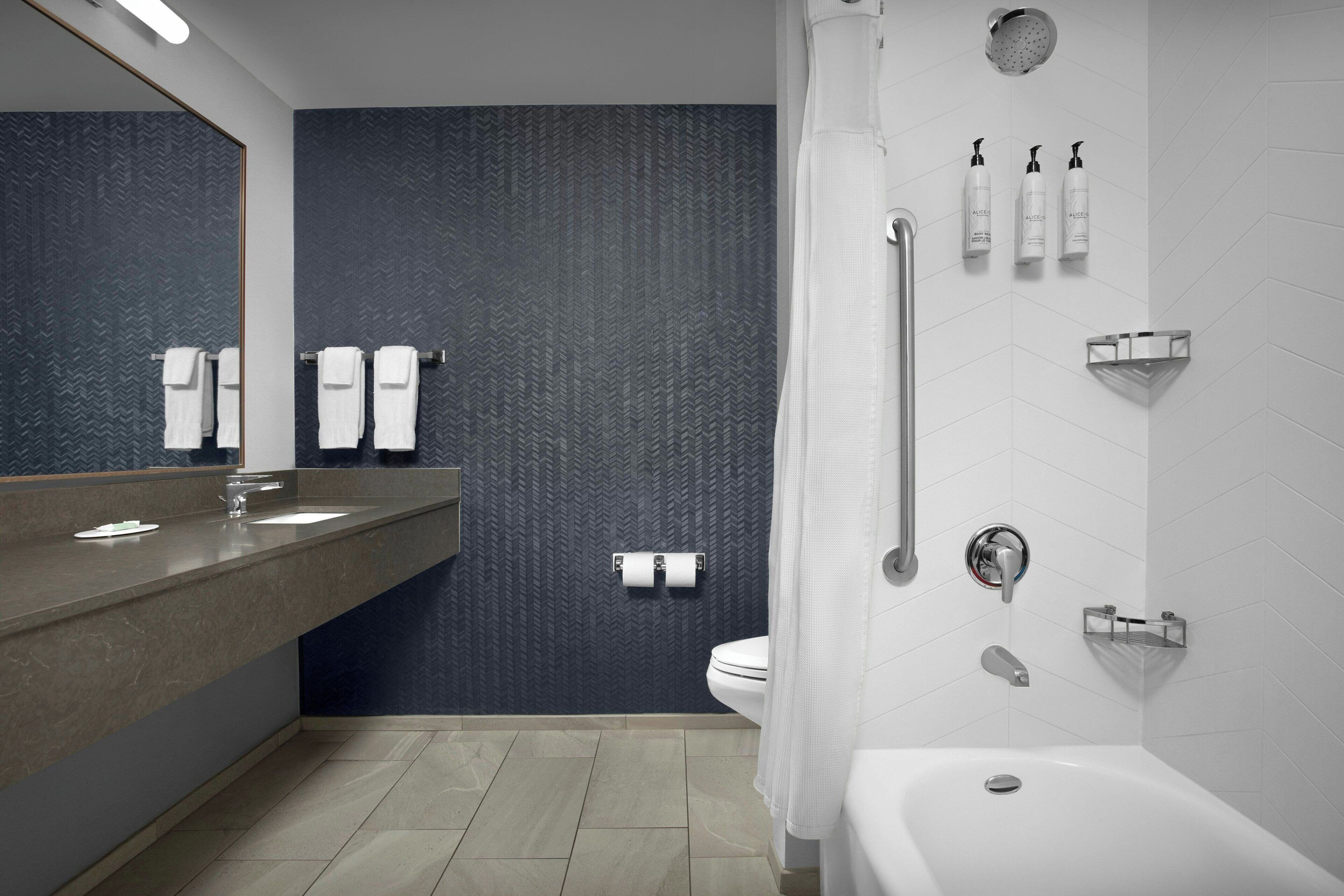 suite, multiple beds | bathroom | combined shower/bathtub, free toiletries, hair dryer, towels