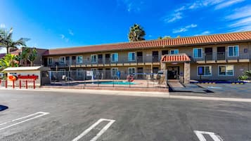 Experience the charm of EconoLodge Inn Suites, featuring a two-story building with a balcony and a convenient entrance lobby.