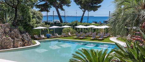 Seasonal outdoor pool, open 10:00 AM to 6:00 PM, pool umbrellas