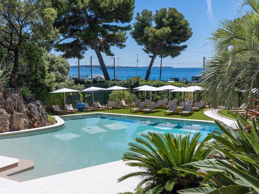 Seasonal outdoor pool, open 10:00 AM to 6:00 PM, pool umbrellas
