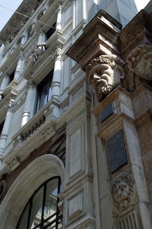 A building with classical architecture, featuring ornate columns and detailed stonework. - Sina The Gray (Milan)