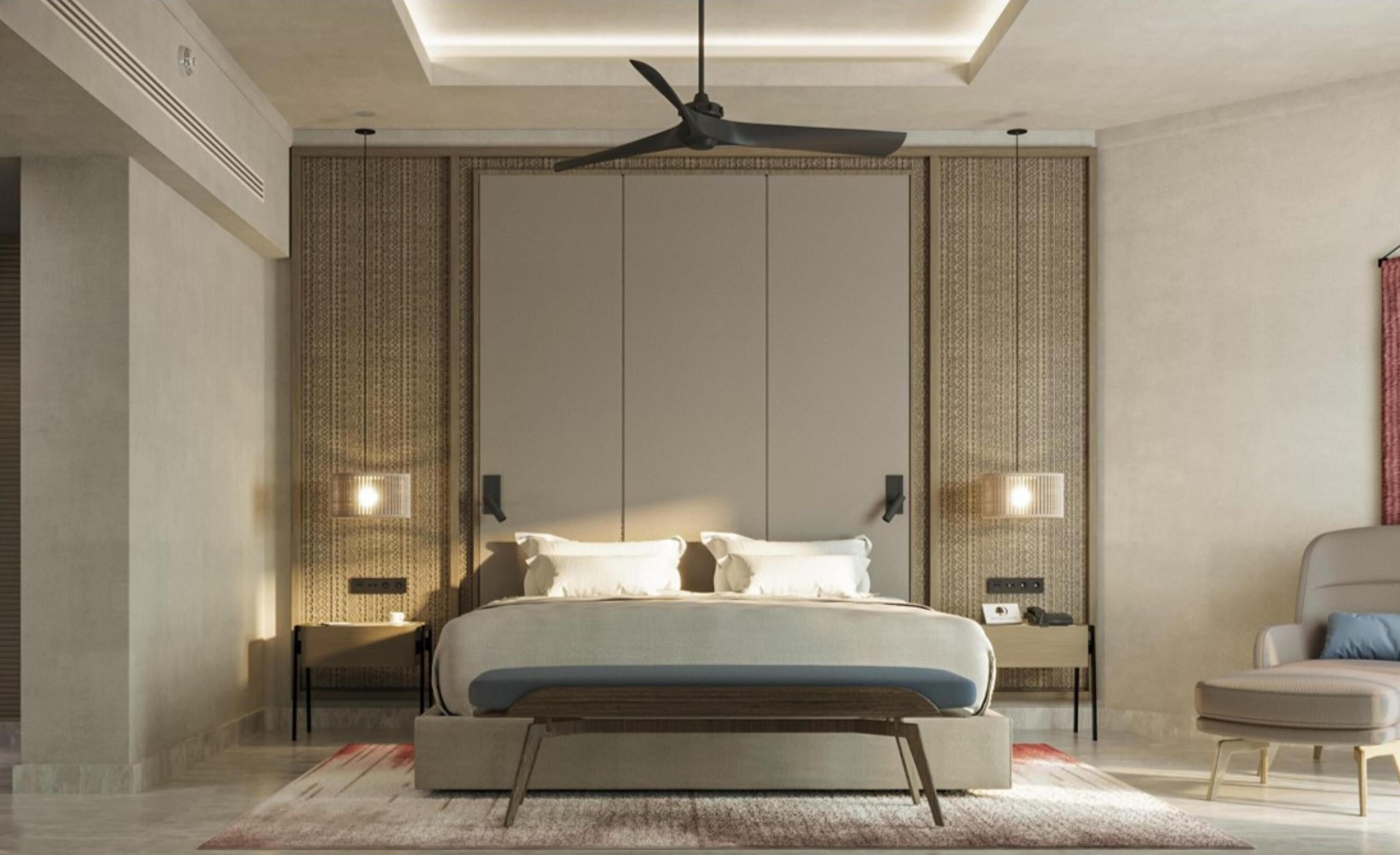 A modern bedroom with a large bed, a ceiling fan, and two bedside lamps.