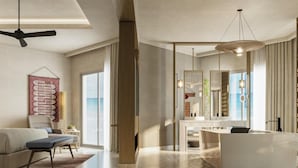 Una habitación de hotel moderna con un ventanal grande, un sofá, un comedor y un baño con un espejo amplio.