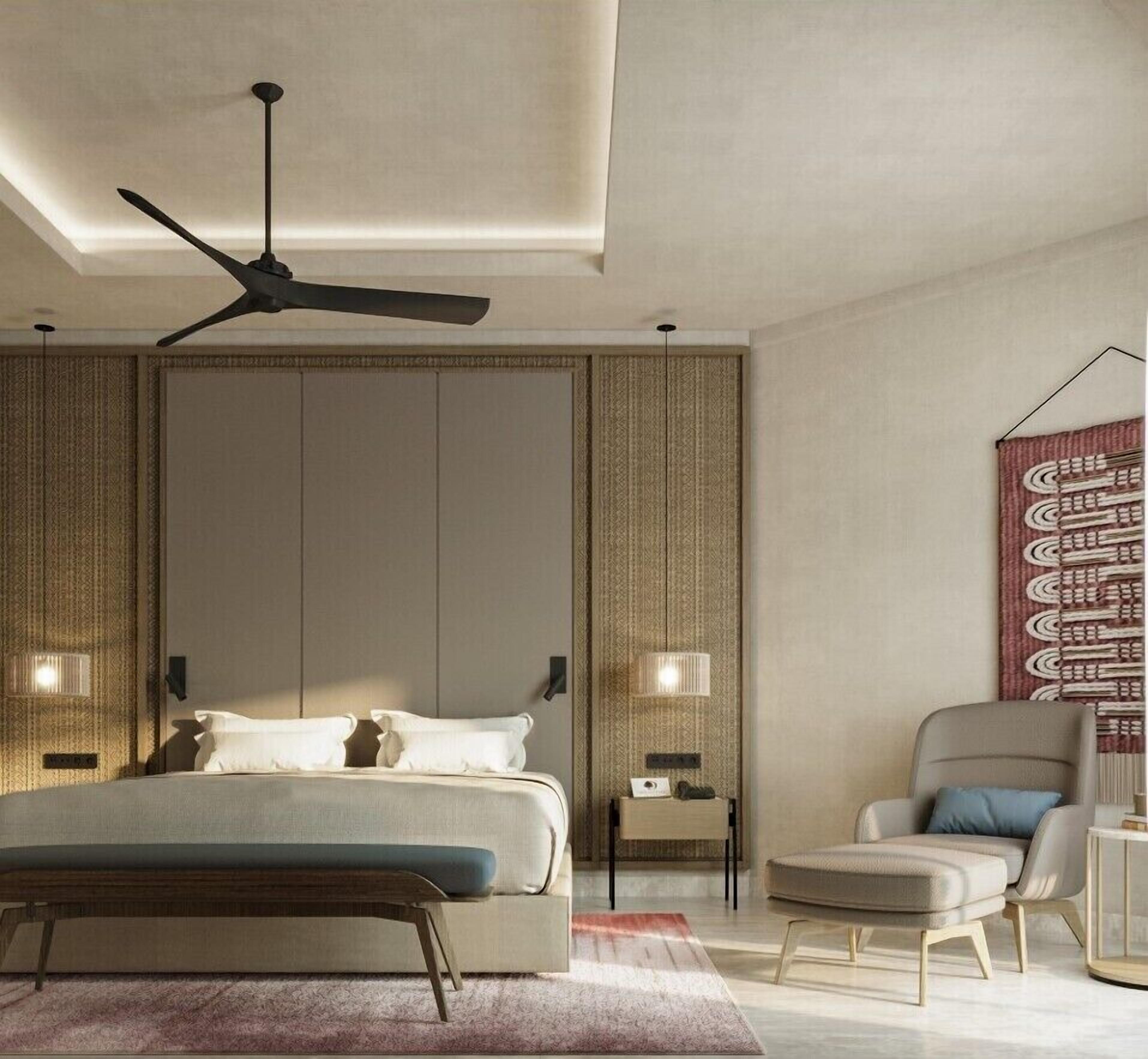 A modern bedroom with a bed, bedside tables, a chair, a ceiling fan, and a patterned tapestry.