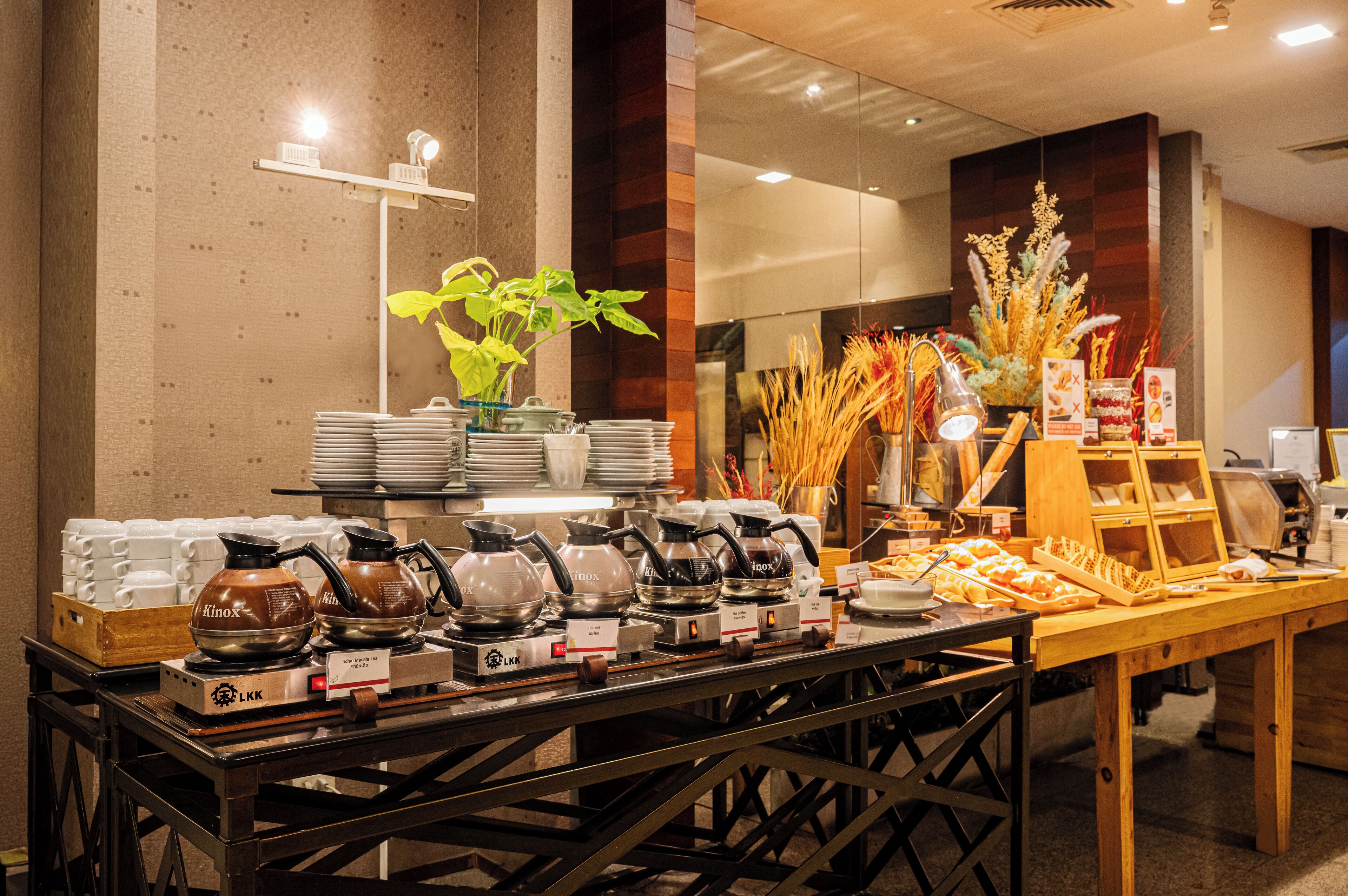 A buffet setup with various dishes and a coffee station.
