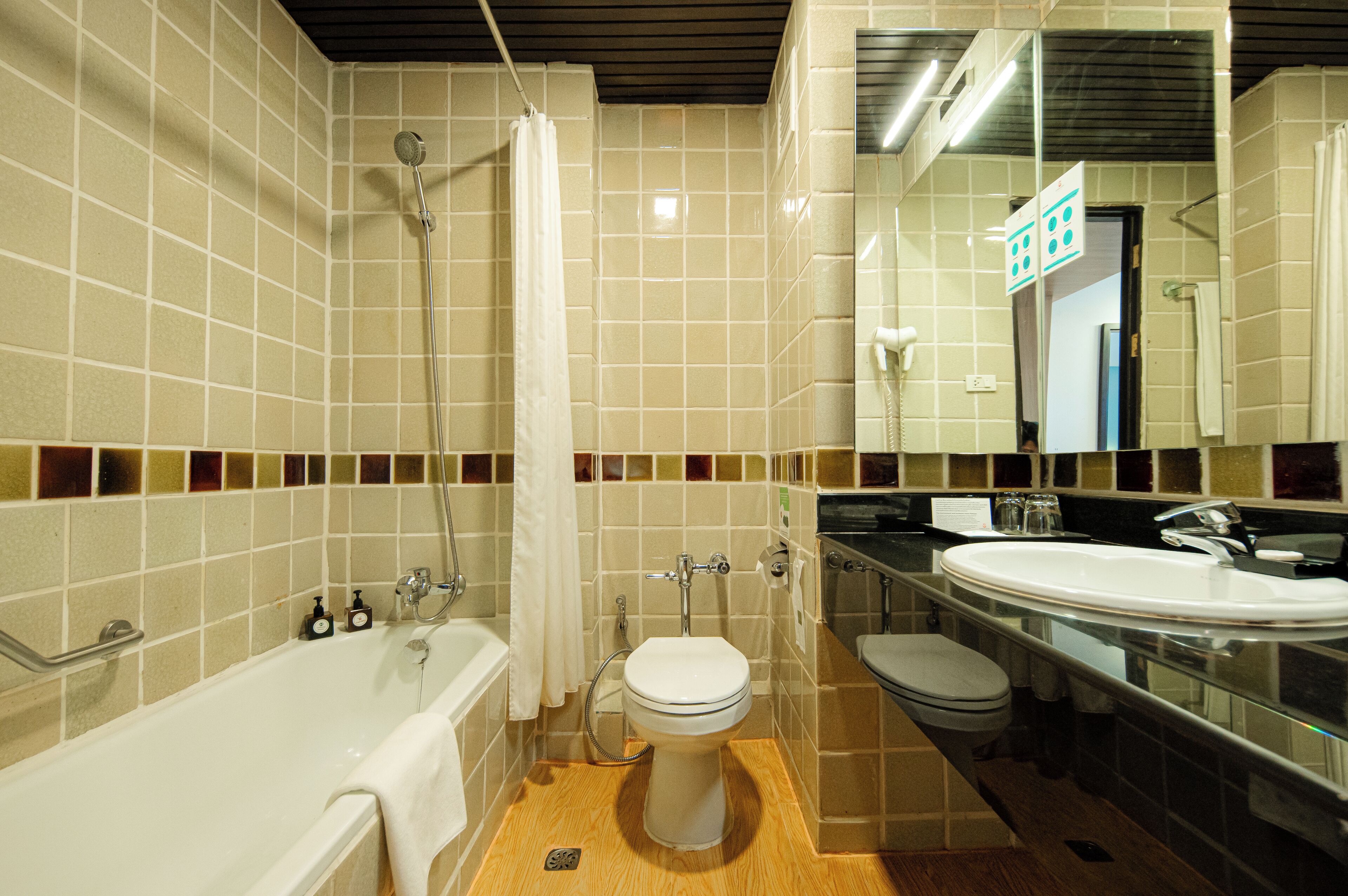 A bathroom with a bathtub, toilet, and sink.