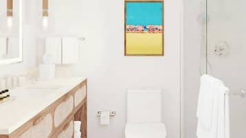 Un baño moderno con tocador de madera, elementos blancos, una fotografía enmarco de playa y una cabina de ducha de vidrio.
