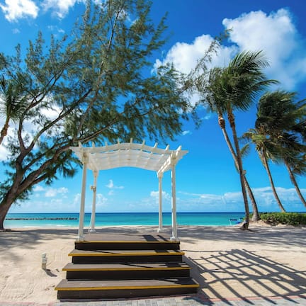 On the beach, white sand, sun loungers, beach umbrellas