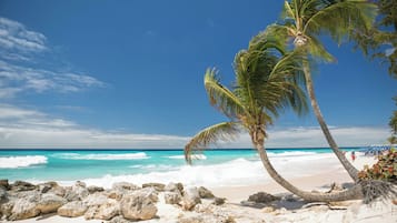 On the beach, white sand, sun-loungers, beach umbrellas