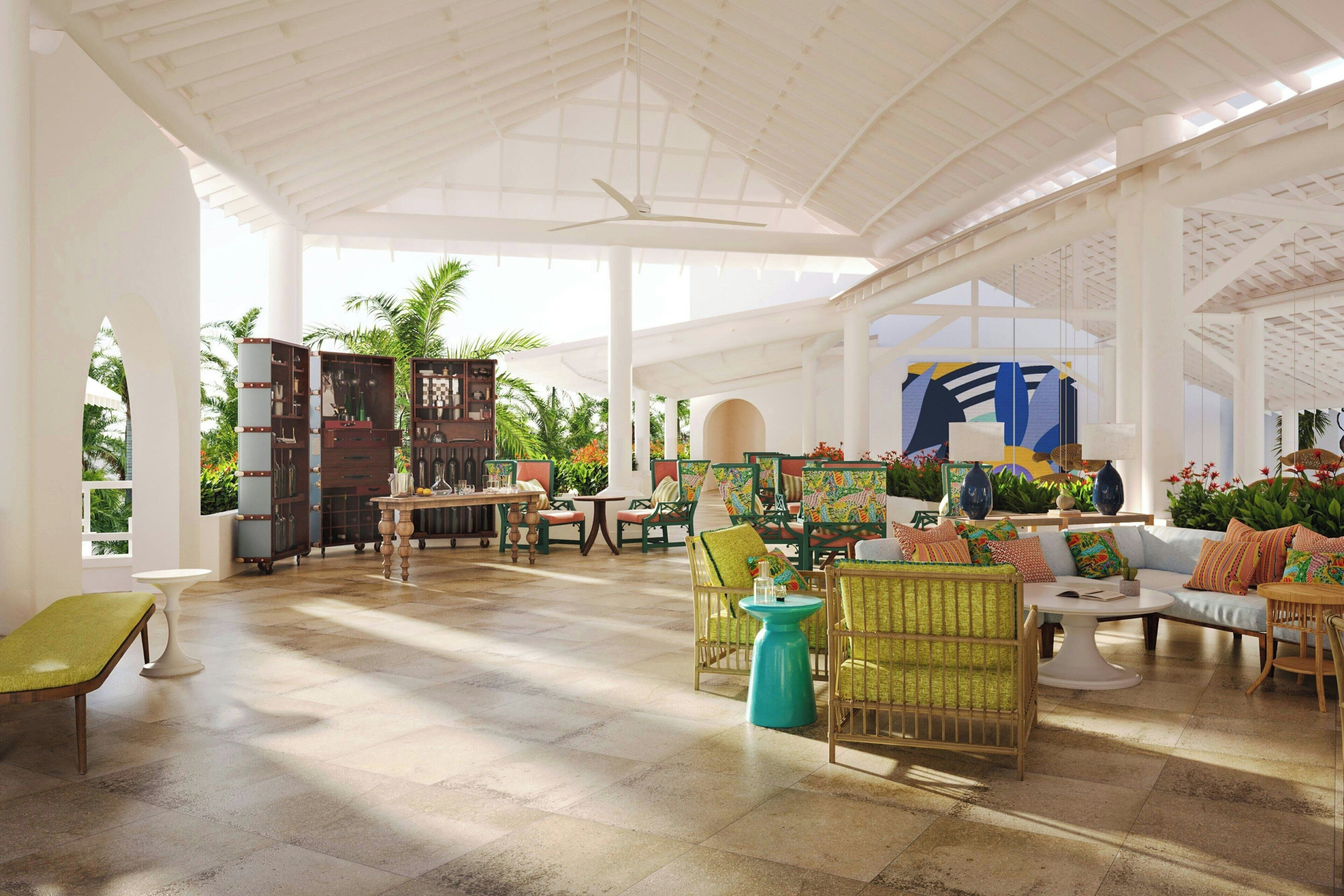 A spacious indoor area with a high ceiling, open space, and a variety of seating arrangements including chairs and sofas.