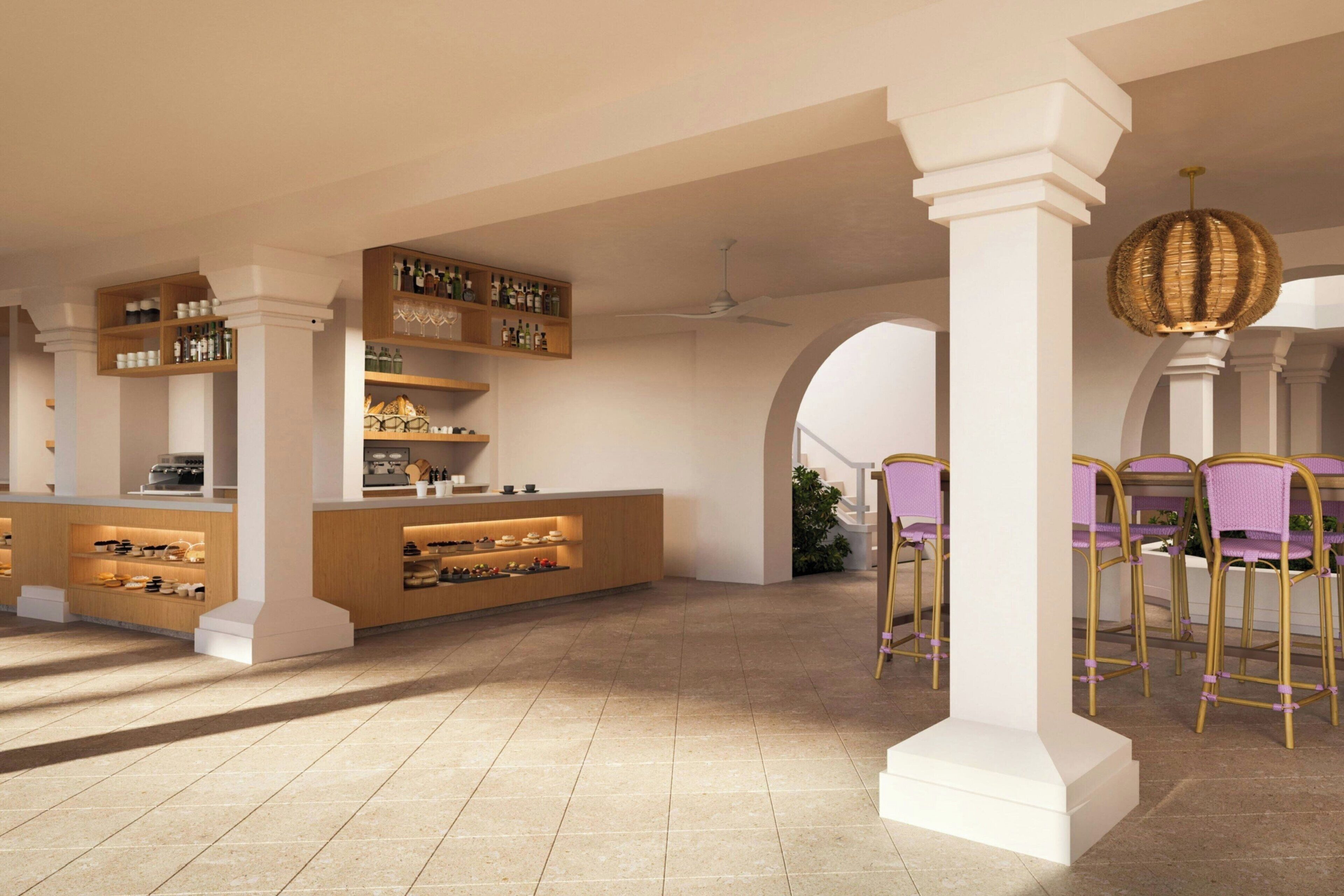 A spacious interior with a central bar area, wooden shelves, and a seating area with chairs.