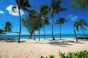 On the beach, white sand, sun-loungers, beach umbrellas