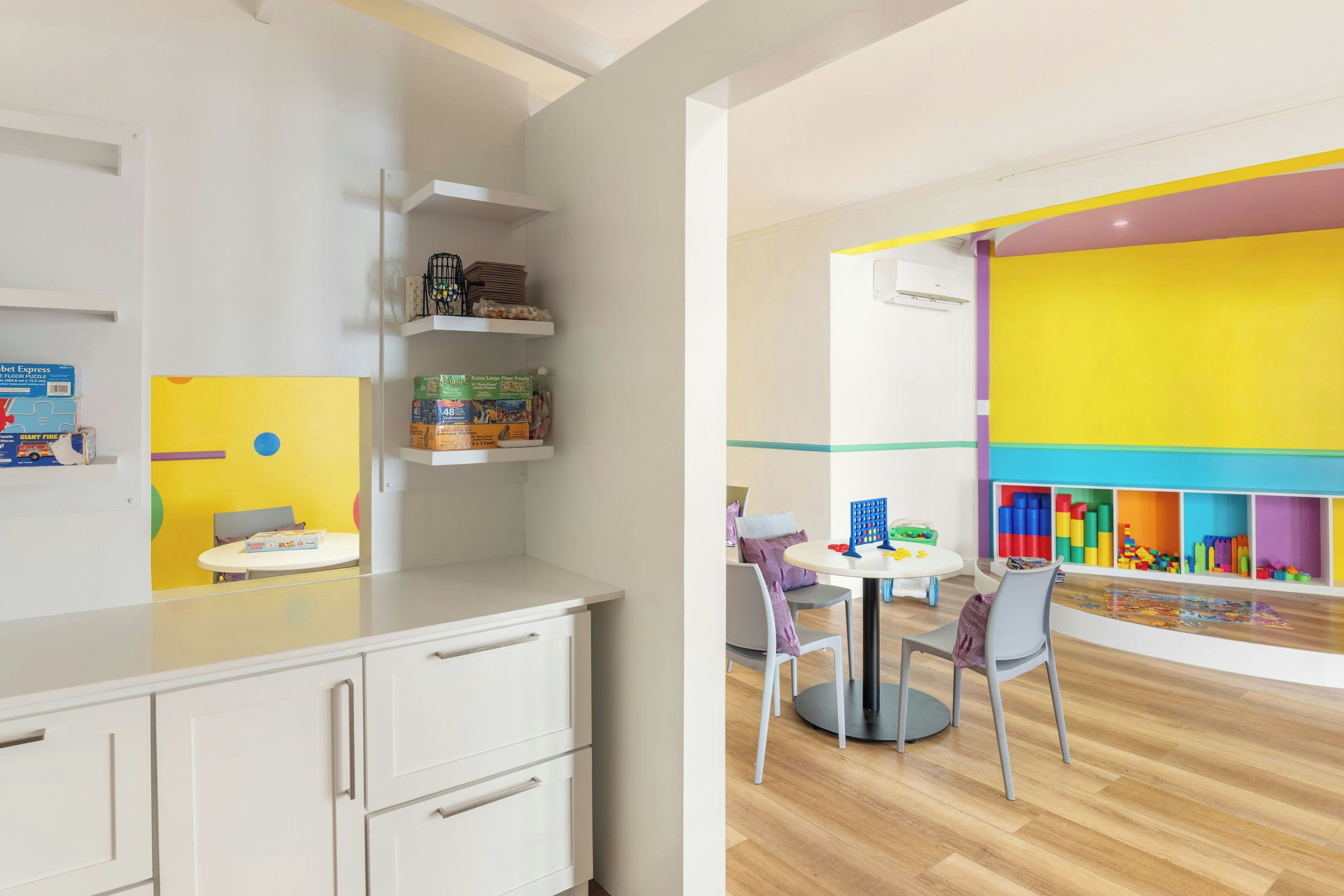 A children's play area with colorful walls and a variety of toys.