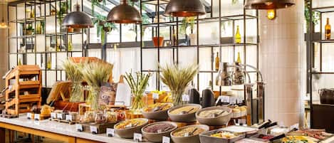 A buffet setup with various food items and a wooden display case.