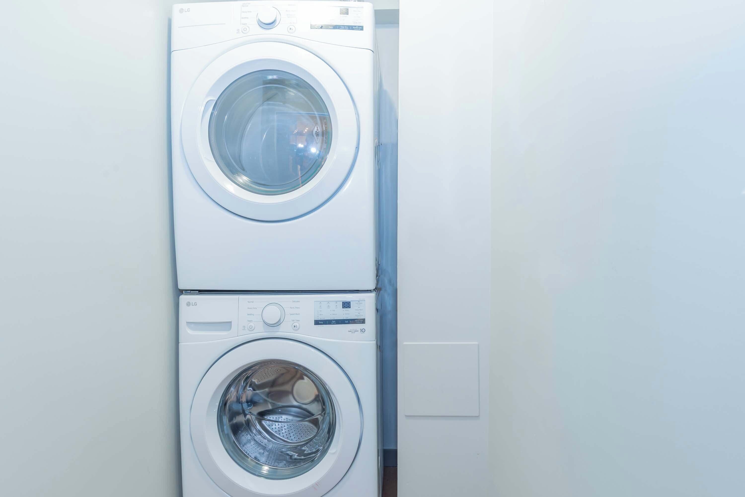 A stacked washer and dryer unit in a laundry room.