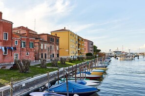A row of colorful buildings along a canal with boats docked.