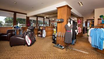 A golf shop with golf bags, clubs, and a display of golf shoes.