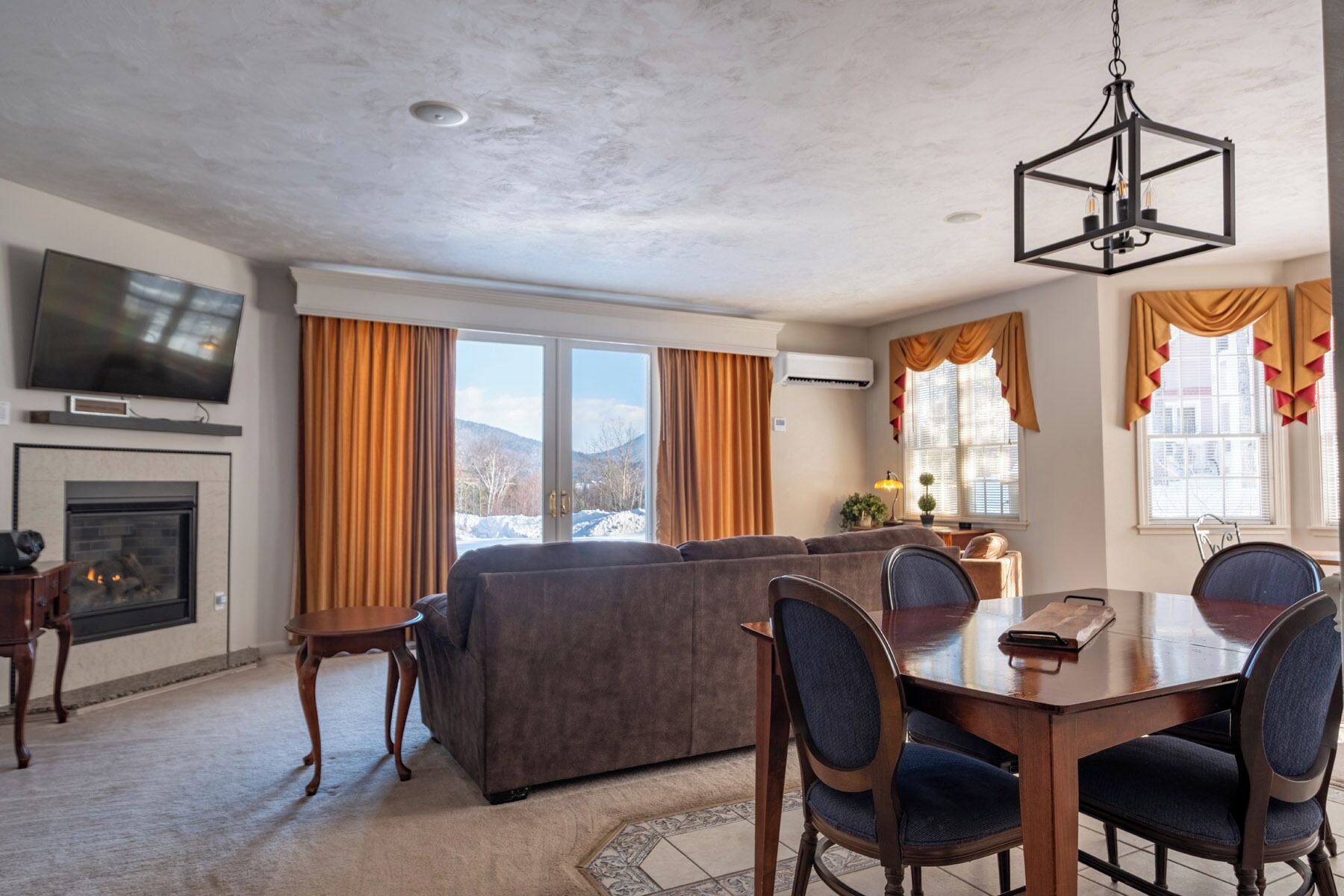 Mountain View Chateau Junior King Suite | Living area | 50-inch TV with cable channels, fireplace, DVD player