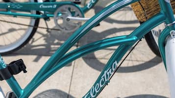 A teal bicycle with the brand name 'Electra' and model 'Cruiser 3' visible on the frame.